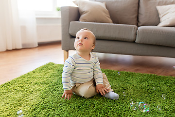 Image showing baby boy playing with soap bubbles at home