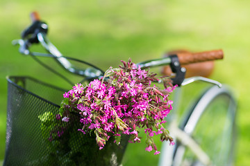 Image showing close up of fixie bicycle with flowers in basket