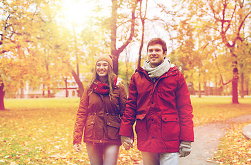 Image showing happy young couple walking in autumn park