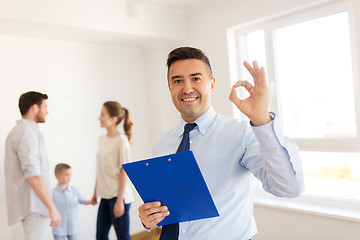 Image showing realtor with clipboard and family at new home