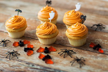 Image showing halloween party decorated cupcakes on wooden table