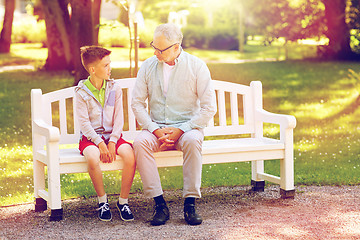 Image showing grandfather and grandson talking at summer park