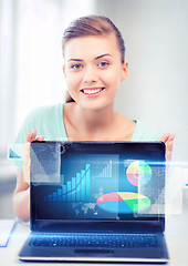 Image showing businesswoman showing laptop with graph