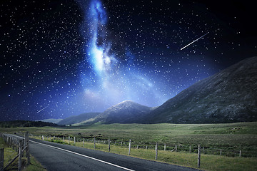 Image showing night landscape of road and mountains over space