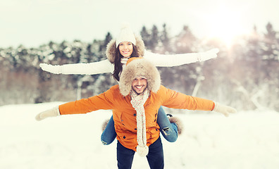 Image showing happy couple having fun over winter background