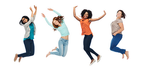 Image showing happy women jumping in air over white background