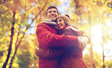 Image showing happy young couple hugging in autumn park