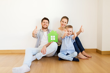 Image showing family with green house showing thumbs up at home