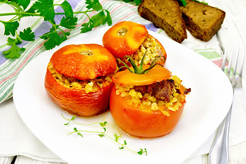 Image showing Tomatoes stuffed with bulgur in plate on table