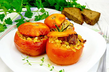 Image showing Tomatoes stuffed with bulgur and meat in plate on table