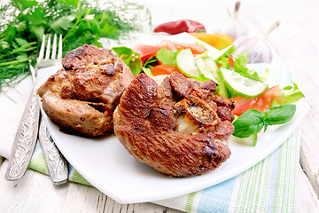 Image showing Turkey steak roasted with vegetables in plate on board