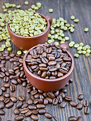 Image showing Coffee black and green grains in cups on board