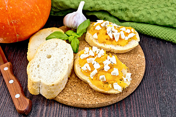 Image showing Bruschetta with pumpkin and basil on board