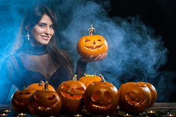 Image showing Woman with Halloween pumpkins