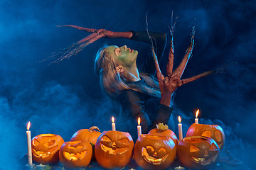 Image showing Halloween costume woman, tree girl with pumpkins