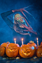 Image showing Halloween costume woman, tree girl with pumpkins