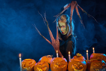 Image showing Halloween costume woman, tree girl with pumpkins