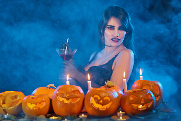 Image showing Sensual witch holding cocktail glass