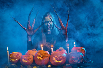 Image showing Halloween costume woman, tree girl with pumpkins