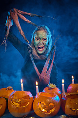 Image showing Halloween costume woman, tree girl with pumpkins