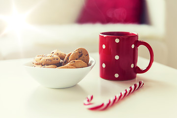 Image showing close up of oat cookies, sugar cane candy and cup