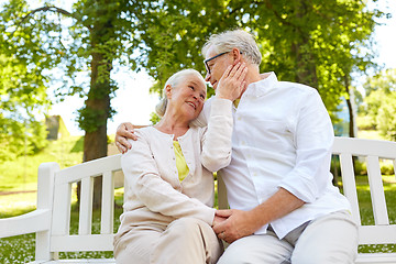 Image showing happy senior couple hugging in city park