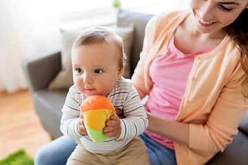 Image showing happy young mother with little baby at home