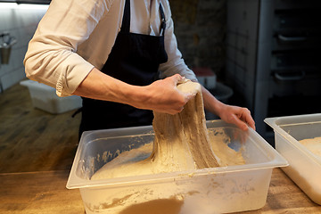 Image showing baker making bread dough at bakery kitchen