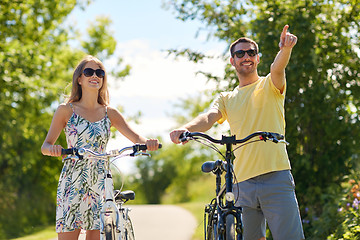 Image showing happy young couple with bicycles outdoors