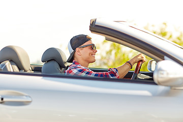 Image showing happy young man in shades driving convertible car