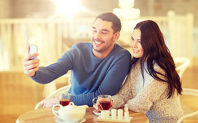 Image showing couple taking smartphone selfie at cafe restaurant