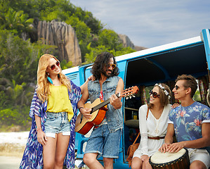 Image showing hippie friends playing music at minivan on beach