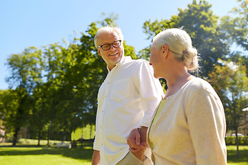 Image showing happy senior couple walking at summer city park