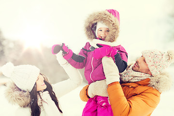 Image showing happy family with child in winter clothes outdoors