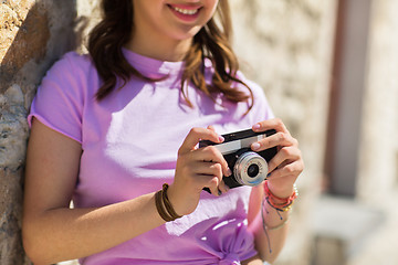 Image showing close up of woman with vintage camera outdoors