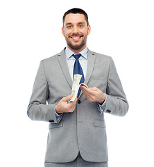 Image showing smiling businessman with american dollar money