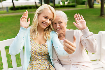 Image showing daughter and senior mother taking selfie at park