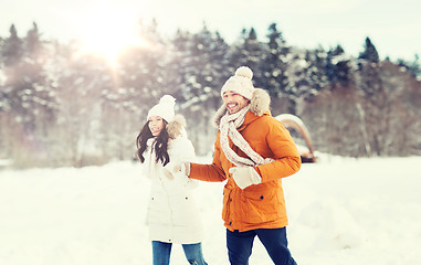 Image showing happy couple running over winter background