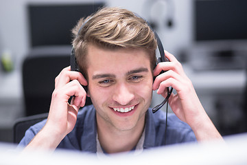 Image showing male call centre operator doing his job