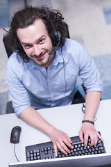 Image showing male call centre operator doing his job top view