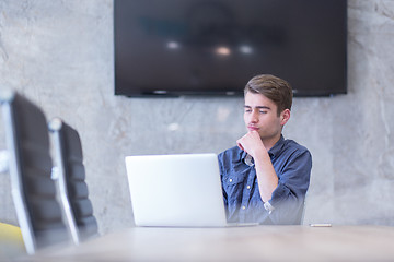 Image showing businessman working using a laptop in startup office