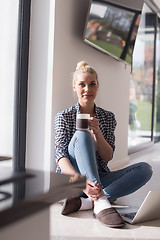 Image showing young woman drinking coffee enjoying relaxing lifestyle