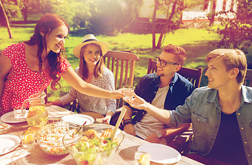 Image showing happy friends having dinner at summer garden party