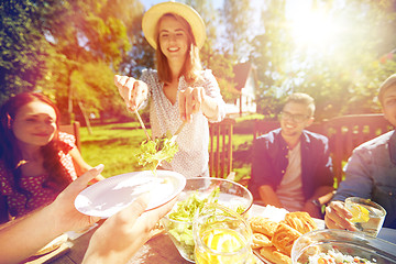 Image showing happy friends having dinner at summer garden party