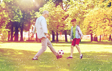 Image showing old man and boy playing football at summer park