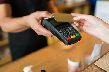 Image showing hands with payment terminal and credit card