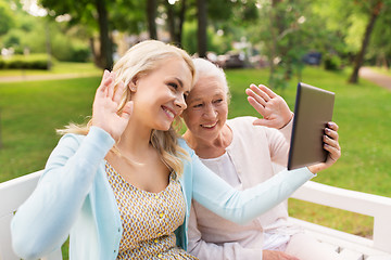 Image showing daughter with tablet pc and senior mother at park