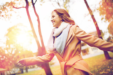 Image showing beautiful happy young woman walking in autumn park