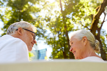 Image showing happy senior couple sitting on bench at park