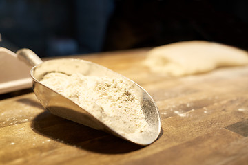 Image showing flour in bakery scoop on kitchen table